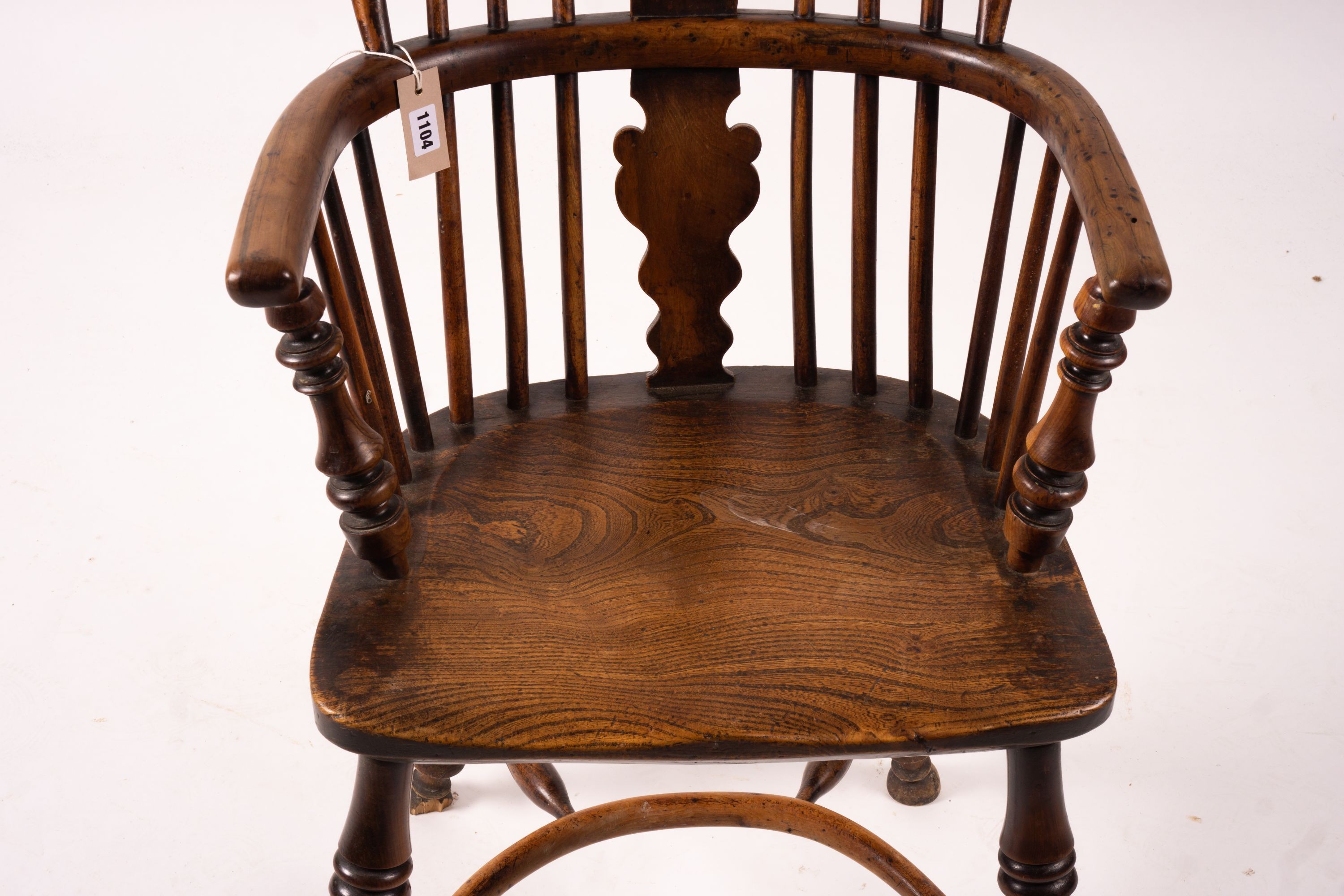 A mid 19th century yew and elm Windsor elbow chair with crinoline stretcher, width 54cm, depth 46cm, height 94cm